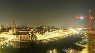 Zurich at night, Limmat river, red construction crane dominating skyline
