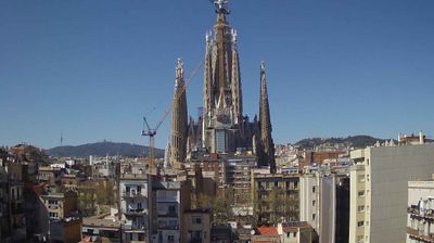 Sagrada Família rising above Barcelona rooftops with cranes