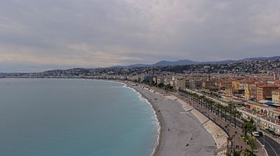 Aerial view of Nice's curved bay, pebble beach, and promenade