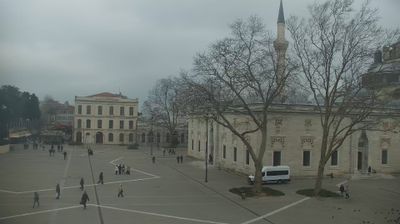 Beyazıt Square with scattered pedestrians, minaret, and foggy light