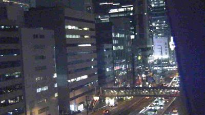 Tokyo at night — lit office windows and expressway between towers