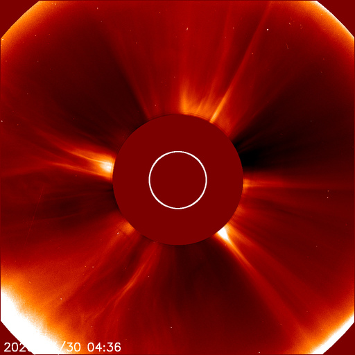 SOHO LASCO C2 coronagraph showing solar corona streamers radiating outward, occulting disk blocking the sun's surface, bright CME-like structure