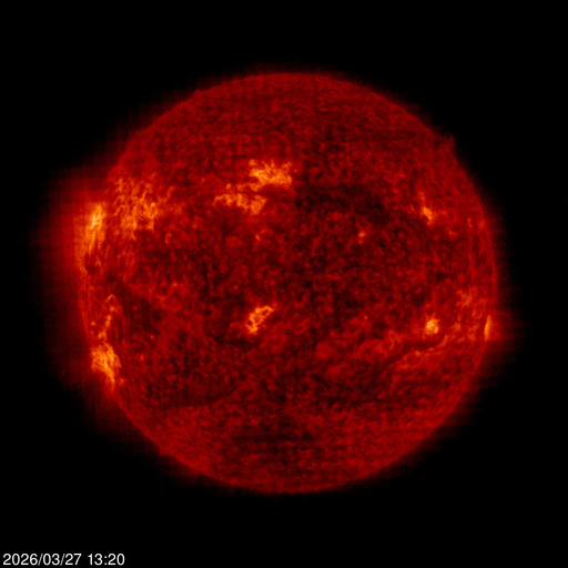 SOHO EIT 304 Angstrom image of the sun's chromosphere, false-color deep red and orange, prominences erupting from the limb, dark filaments crossing the disk