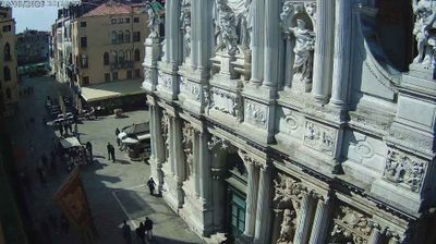 Venice — baroque facade of Santa Maria del Giglio church, ornate stone carvings, tiny figures at base of enormous building