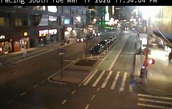 Manhattan street at 11:54 PM — cars, streetlights, crosswalk, urban glow, facing south